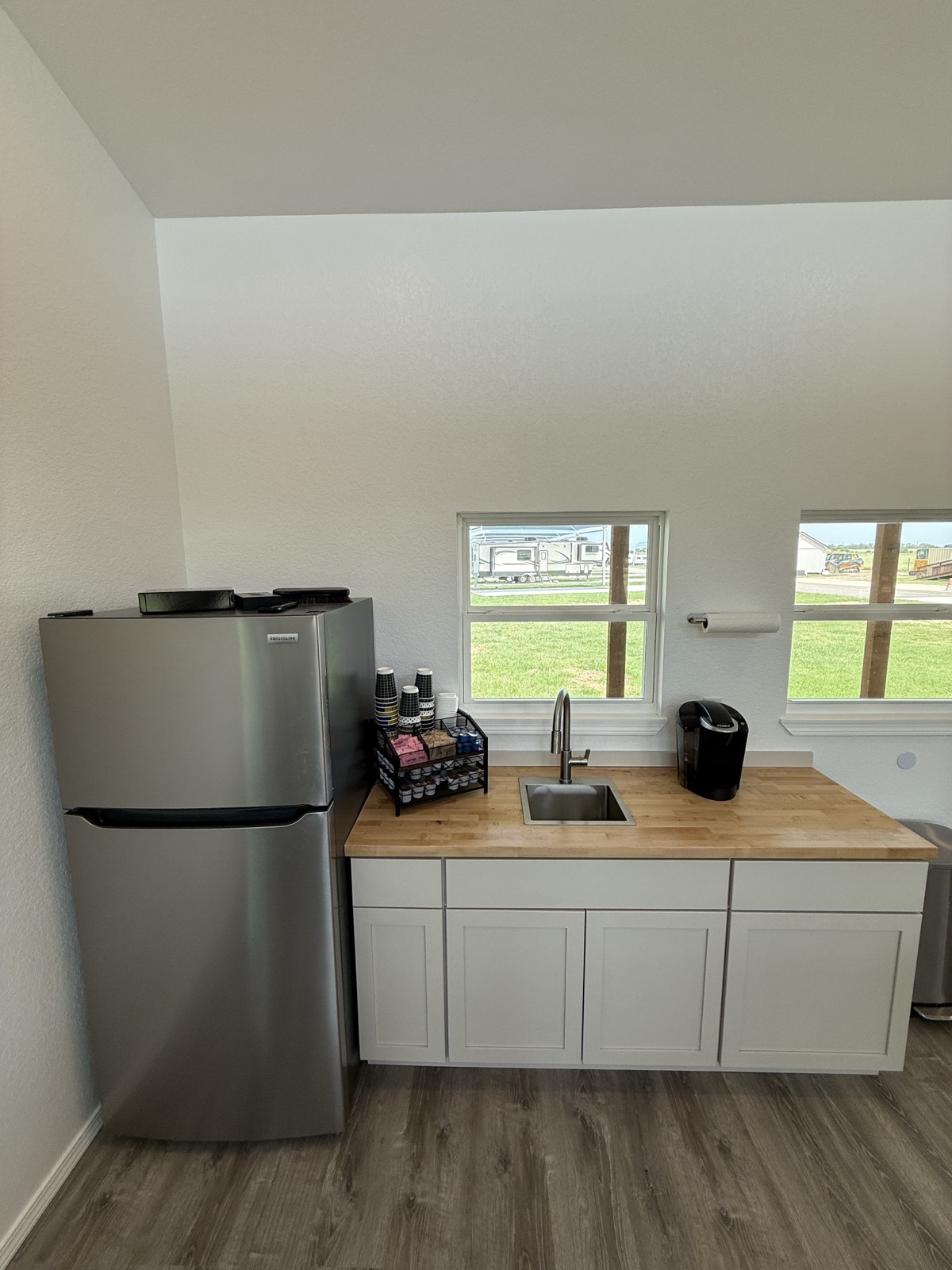Clubhouse coffee bar with Keurig, sink, and refrigerator at Shade Stop RV of Floresville